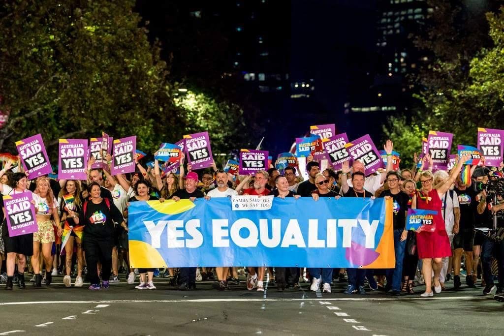 A parade of colour showing the Yes Equality signs